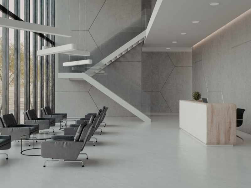 Interior de un lobby de oficinas moderno y elegante, con personal de recepción y seguridad atendiendo a visitantes. Estilo corporativo de alta gama.